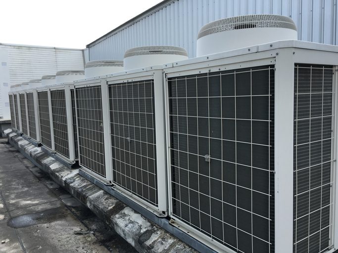 Row of rooftop commercial HVAC condenser units