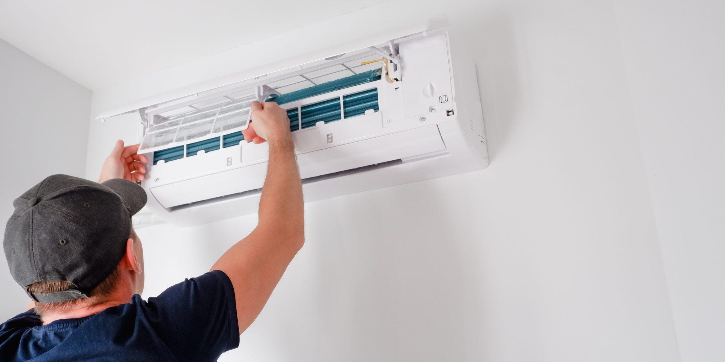 Technician servicing wall-mounted air conditioner