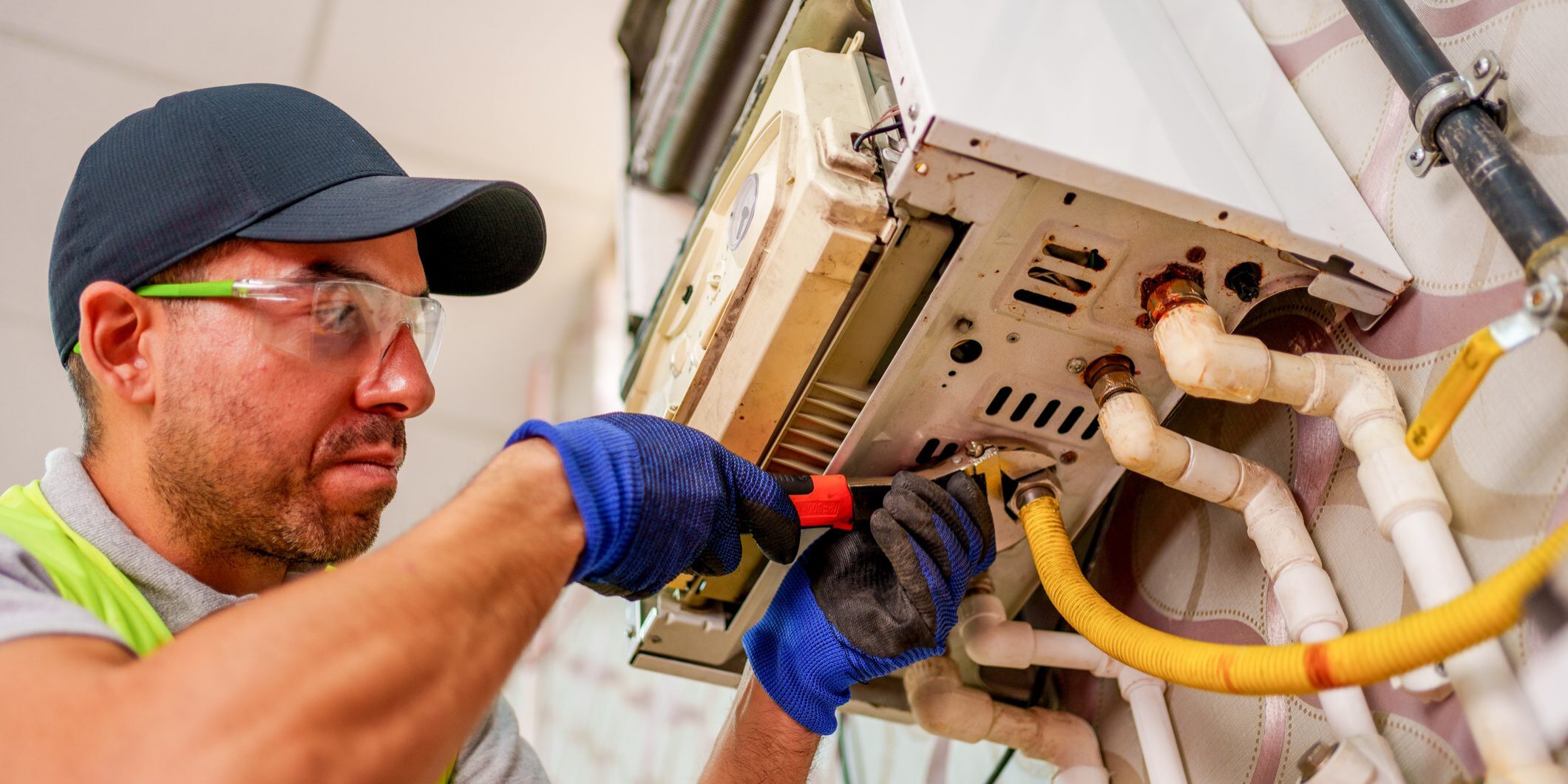 Technician repairing wall-mounted heating unit