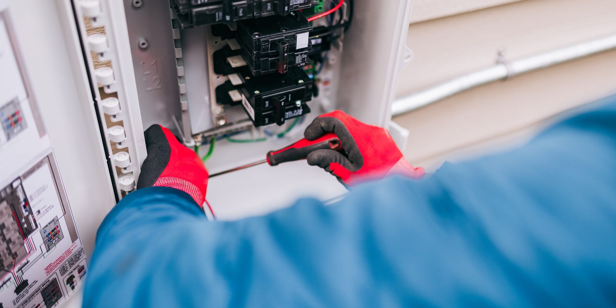 Electrician repairing residential electrical breaker panel