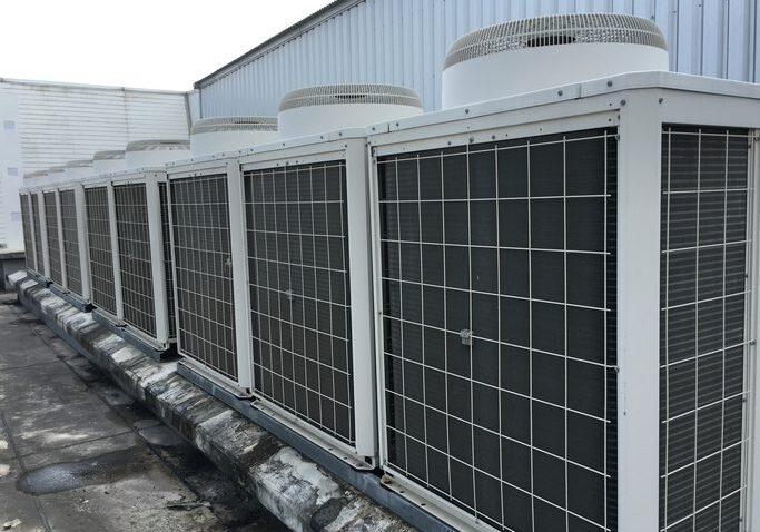 Row of rooftop commercial HVAC condenser units